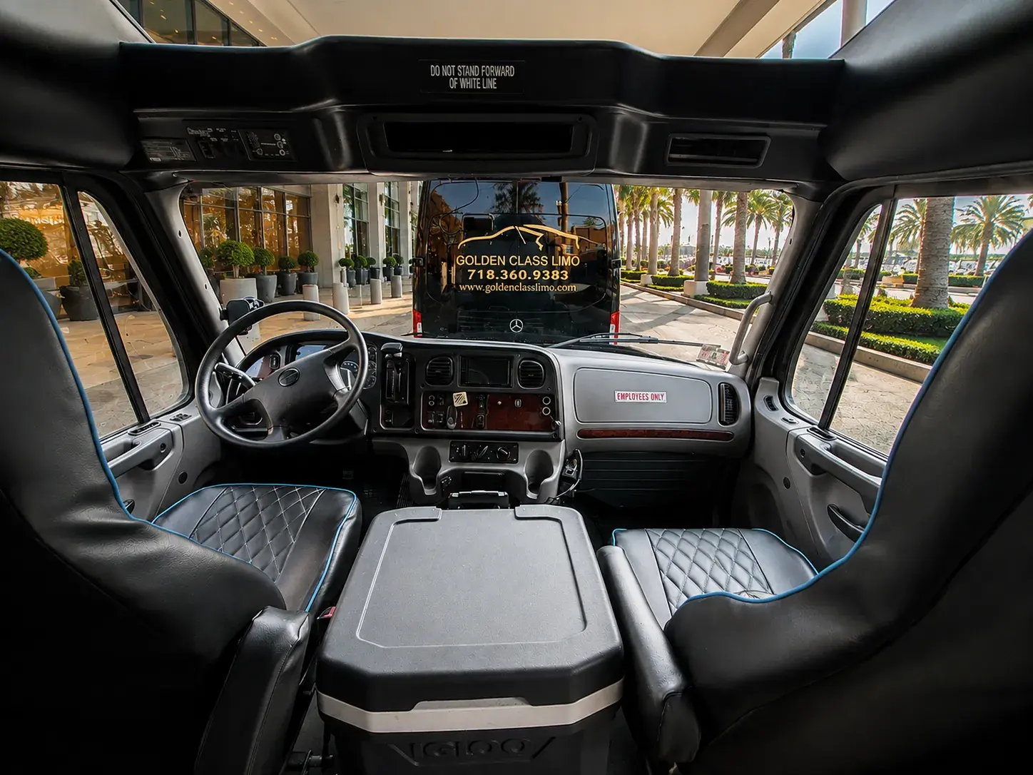 Driver's cab of a Golden Class Limo bus, looking out at another vehicle in the fleet