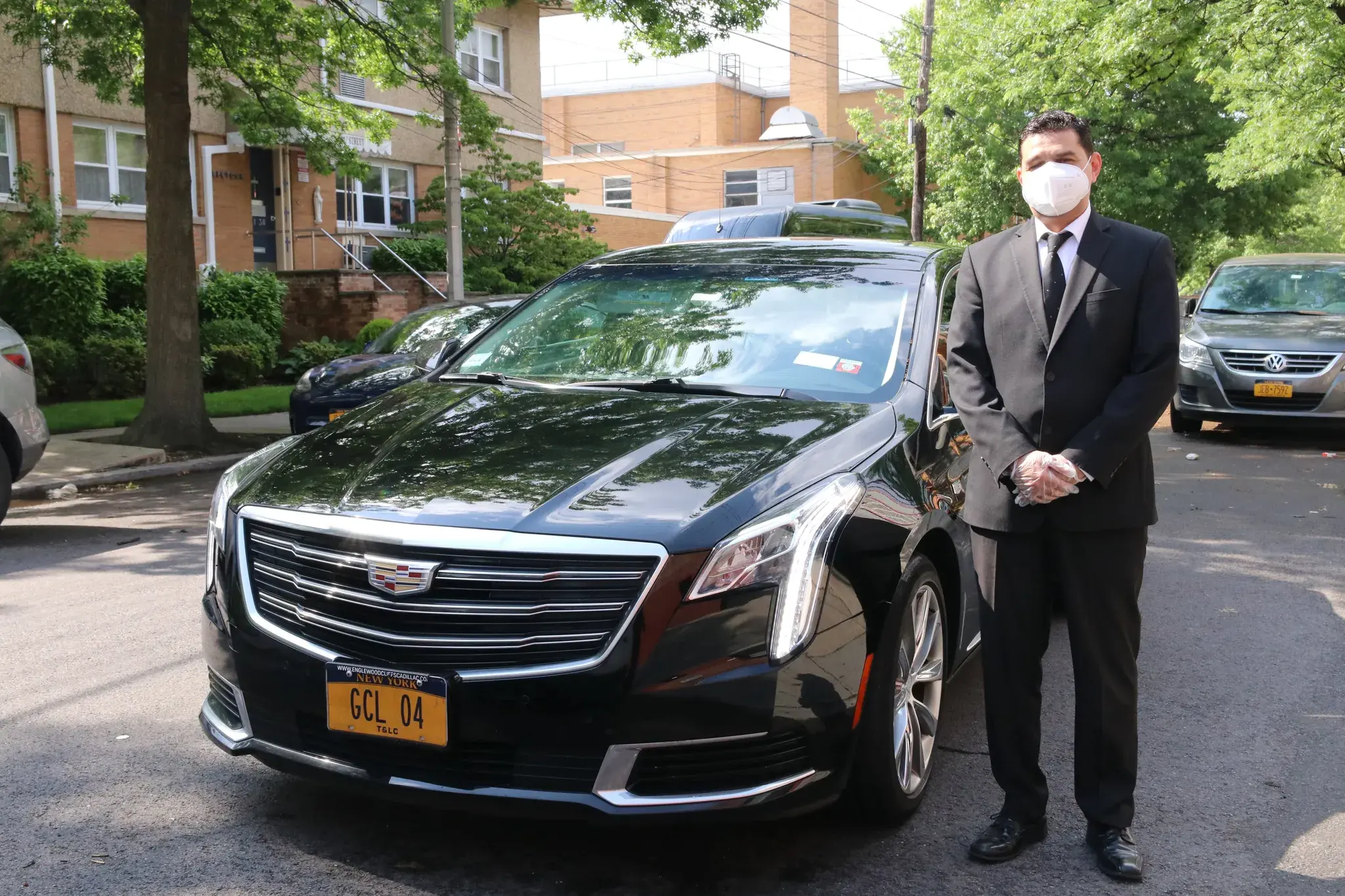 The Executive Sedan photographed head-on with its chauffeur, plate GCL 04