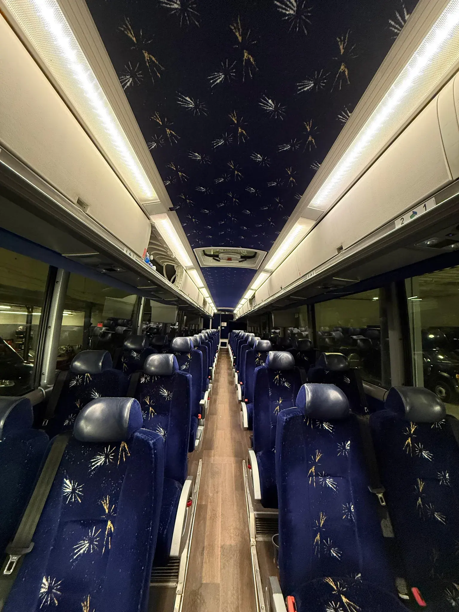 Inside the motor coach, rows of reclining seats running the length of the aisle