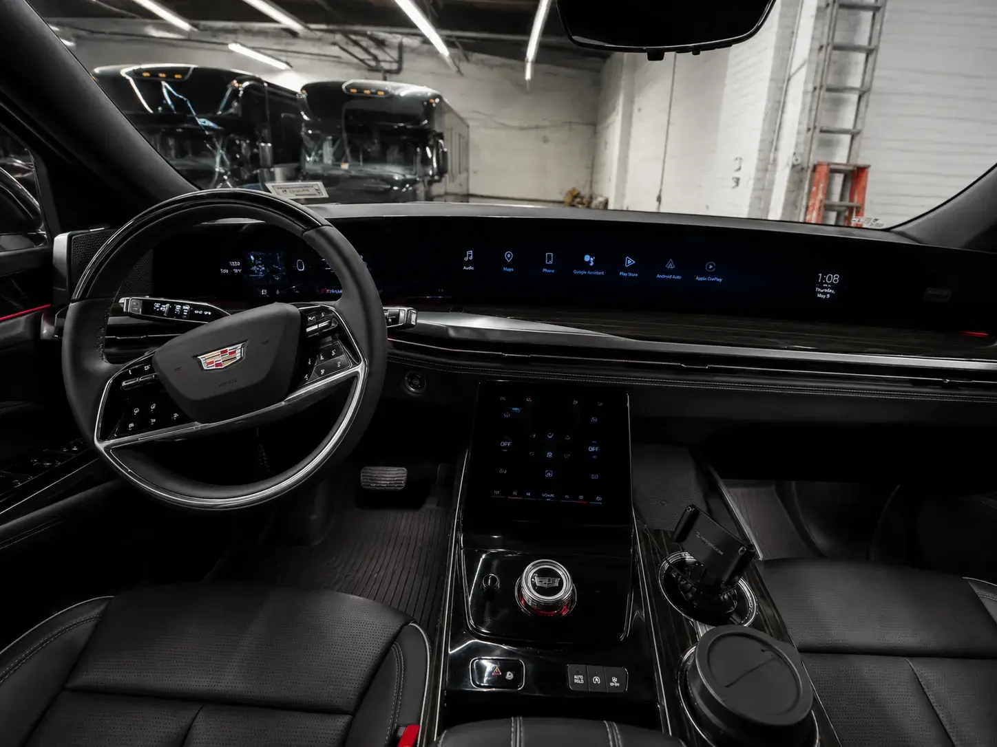Driver's view inside the Escalade ESV, curved dashboard display and Cadillac steering wheel