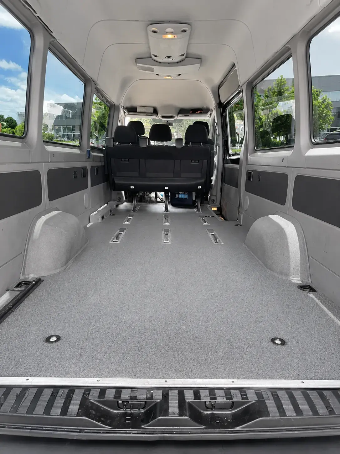 Inside the Cargo Sprinter van, an empty load floor running the length of the body with tie-down rails set into it and no passenger seating
