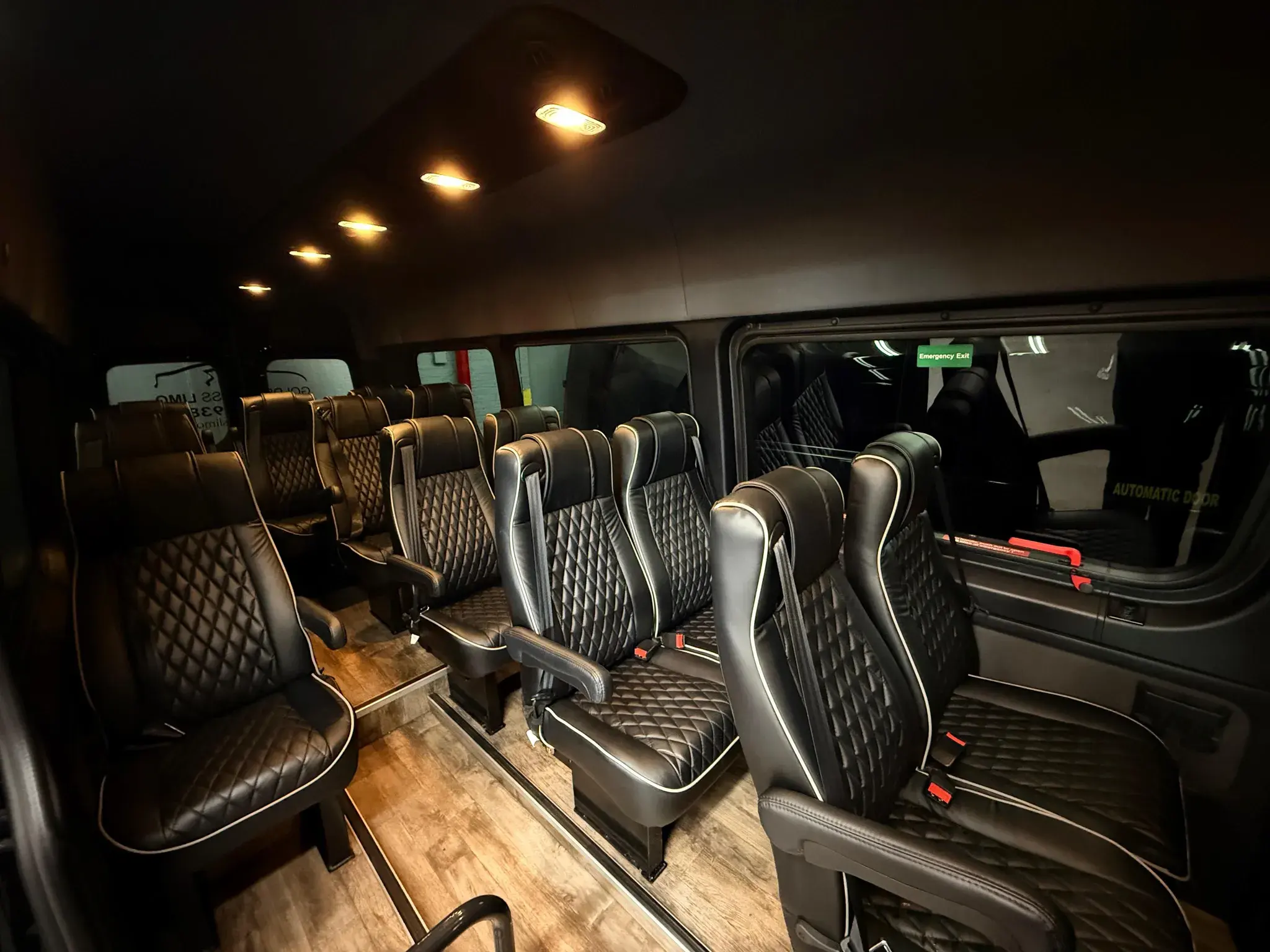 Standard Sprinter cabin looking toward the rear rows, with the automatic side door open
