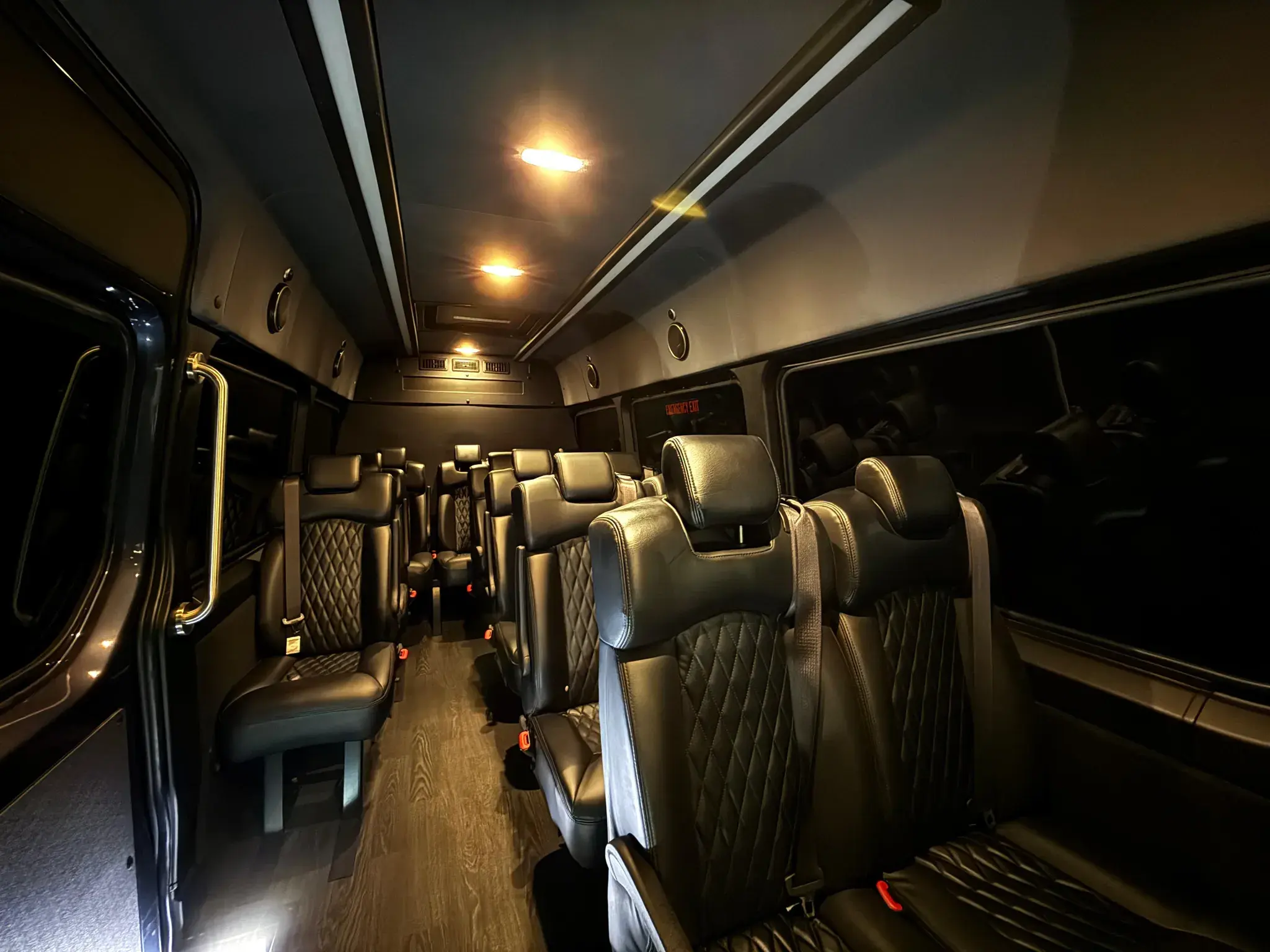 Inside a Golden Class Limo Mercedes-Benz Sprinter — black quilted-leather seats under warm cabin lighting