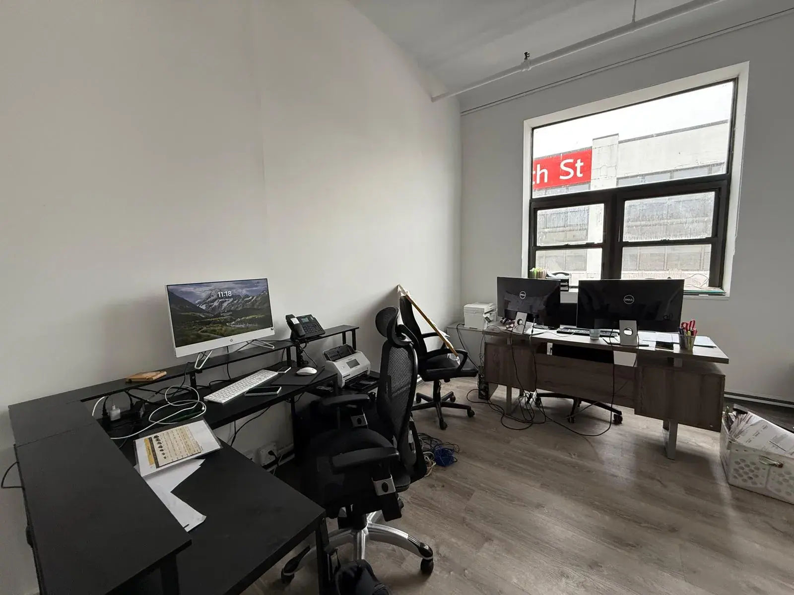The Golden Class Limo dispatch office, desks and monitors with the 35th Street sign visible through the window