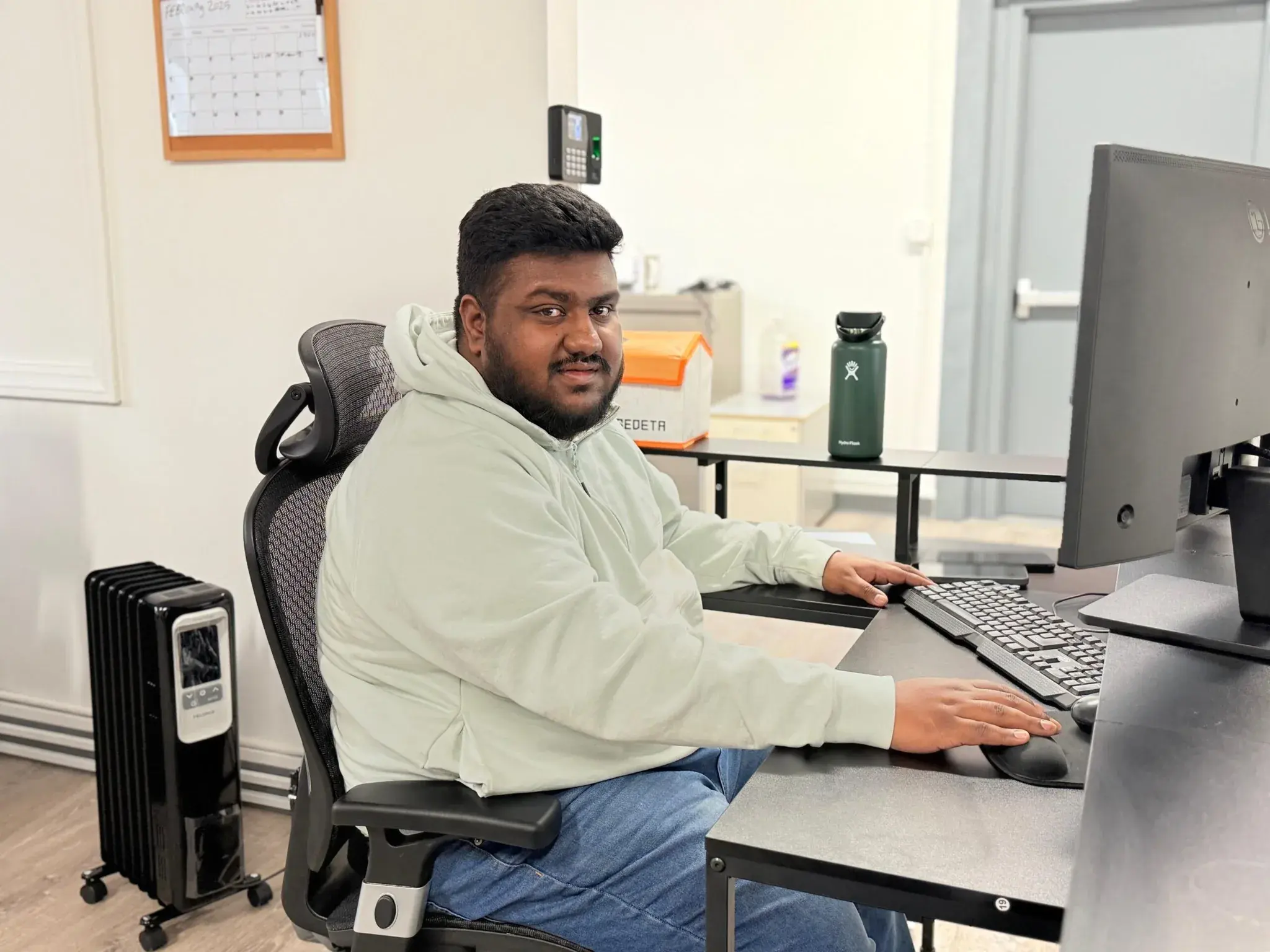 Abdullah, Dispatch Manager at Golden Class Limo, at his workstation