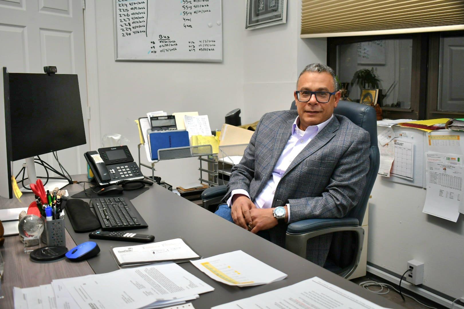 Ibrahim Mosa, Founder and CEO of Golden Class Limo, at his desk
