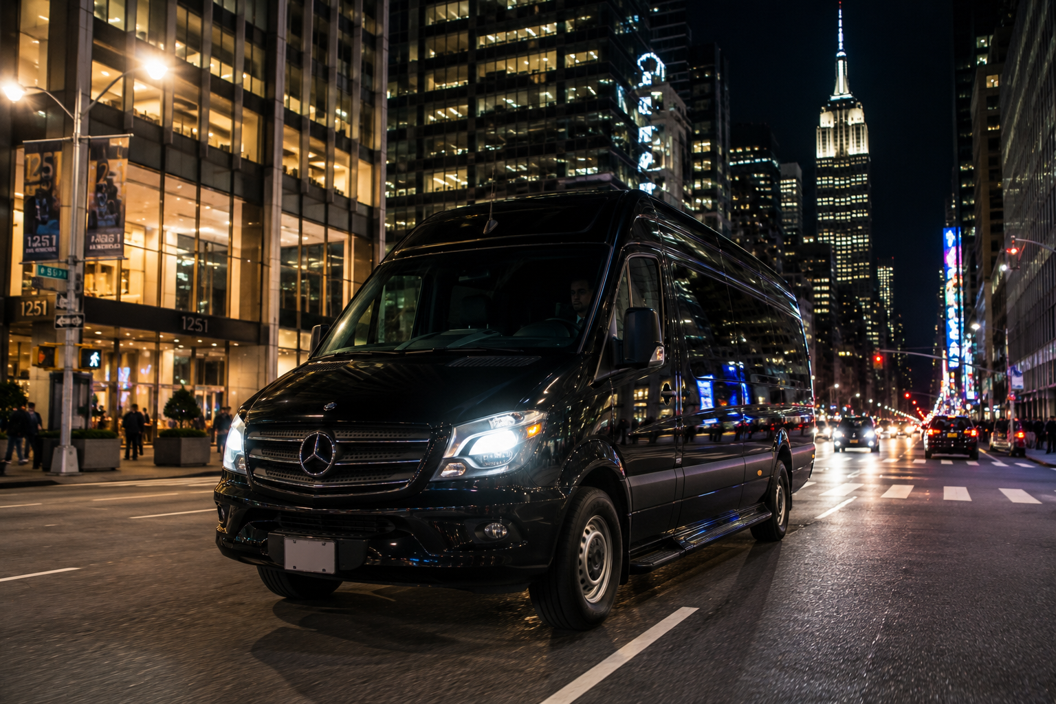 Sprinter van driving through Manhattan at night with city lights